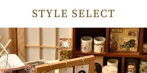 Detailed view of vintage washi tape rolls in a rustic wooden shelf with candles