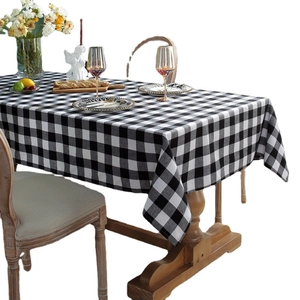 Classic black and white checkered table cloth on a rustic wooden dining table setup