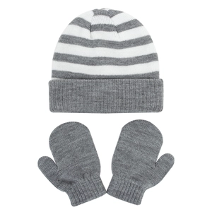 Close-up of children's grey and white striped knit beanie and glove set for winter