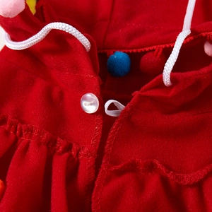 Detail of red pet Christmas cloak showing white drawstring and pearl button closure