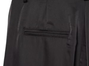 Detailed close-up showing the professional stitching and welt pocket of the black satin pants