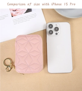 Pink quilted mini cosmetic bag shown next to iPhone 15 Pro for size comparison