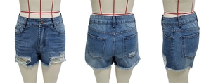 Three-way view of blue denim shorts with distressed holes and frayed raw edge detail
