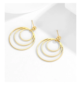 Close-up of golden stainless steel triple-layered concentric circle drop earrings