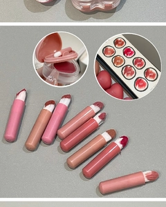Lip and cheek mud palette showing eight shades with a heart puff and soft lighting