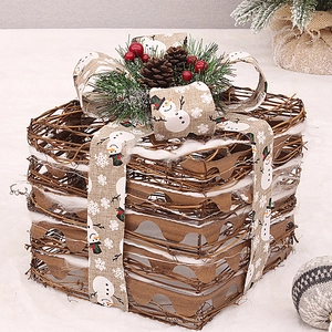 Detail of natural rattan Christmas gift box with snowmen ribbon, pine cones and berries