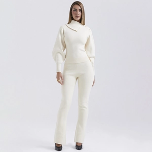 Chic cream-colored knitted two-piece set with a high neck diagonal button top and matching pants