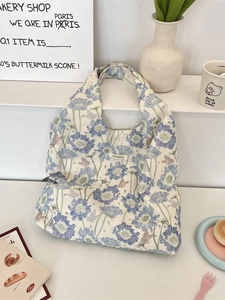 Floral canvas tote bag with blue flowers and purple butterflies in a lifestyle setting