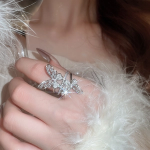 Detailed view of shimmering silver butterfly ring with pavé-set sparkling zircons