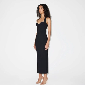 Elegant side view of a black halter neck maxi dress with a slim fit waist and side slit