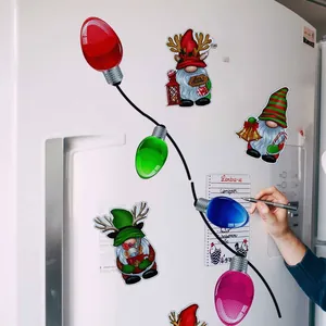 Christmas gnomes and colorful bulb magnets displayed on a white refrigerator surface