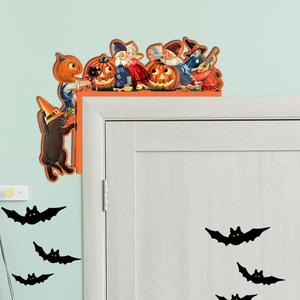 Close-up of vintage Halloween wooden door corner decor featuring pumpkins and witches