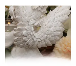 Detailed macro view of white angel wing feathers showing intricate resin carvings