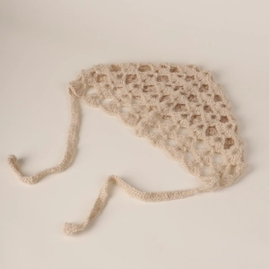 Detail view of handmade beige crochet bandana with vintage floral hollow pattern