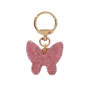 Close-up of sparkling pink rhinestone bow keychain with golden metal ring and chain