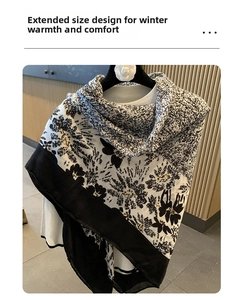 Detail of long cotton linen shawl featuring black and white floral prints and soft texture