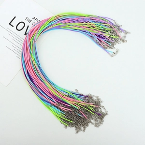 Close-up of colorful waxed necklace cords with silver lobster clasps and extension chains