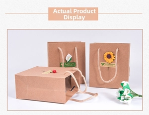 Detail of vintage kraft paper gift bags with floral decor and woven rope handles