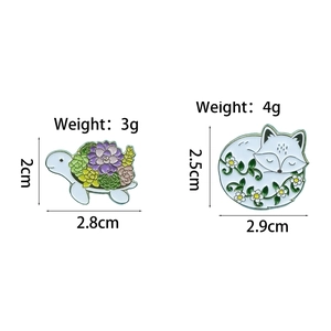 Creative animal enamel pins featuring a turtle with succulents and a sleeping floral fox