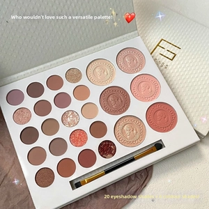 Detail view of 26-color makeup palette with embossed blush powders and professional brush