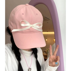 Pink cotton baseball cap with white satin bow detail for a sweet feminine aesthetic