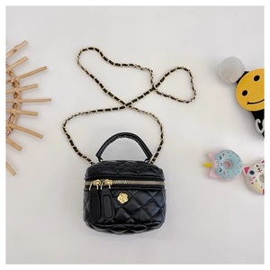 Close-up of black quilted round bag with gold camellia hardware and chain strap