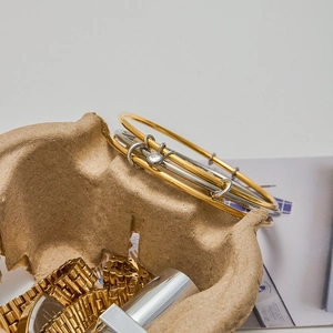Detailed macro view of two-tone 18K gold and silver stainless steel bangles with zircon