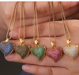 Macro view of five colorful heart pendants with micro-pave cubic zirconia on gold box chains