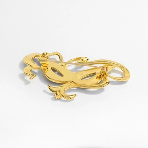 Golden wavy abstract mask brooch with secure pin back on white background