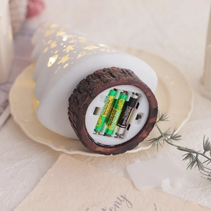 Illuminated white Christmas tree desktop decoration with a wood-grain base and battery slot