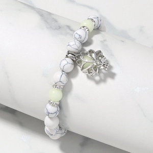 Luminous lotus charm bracelet with white turquoise beads and glow-in-the-dark stones
