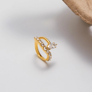Detail of gold titanium steel ring featuring marquise cut zircon stones and pavé setting