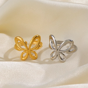 Exquisite 18K gold and silver butterfly open rings on elegant white silk fabric