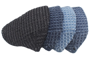 Close-up of distressed denim newsboy caps in black, navy, indigo, and light blue shades