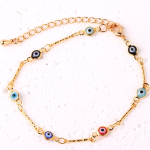 Close-up of gold-plated bracelet featuring colorful evil eye charms and lobster clasp detail