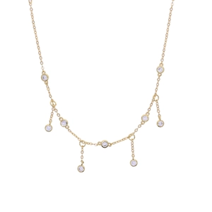 Close-up of golden anklet chain featuring delicate round clear zircon crystal charms