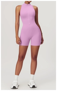 Front view of pink sleeveless yoga romper featuring a high neck and front zipper detail