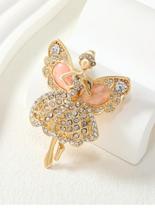 Macro shot of a vintage gold butterfly fairy brooch with pink cat-eye stones and rhinestones