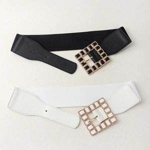 Detail of square acrylic rhinestone buckles on black and white elastic 6cm wide belts