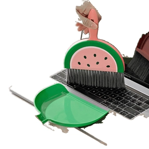 Mini watermelon-shaped broom and dustpan set for desktop cleaning on laptop keyboard