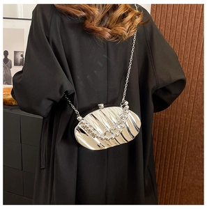 Silver metallic leaf-shaped evening clutch with wavy texture and gradient beads decor