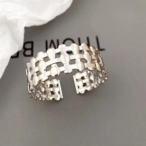 Detailed macro view of silver mesh hollow open bangle with polished metallic finish