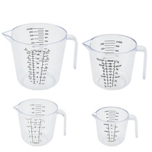 Clear plastic measuring cups set with handles and visible metric scales for baking