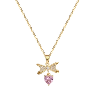 Elegant gold titanium necklace featuring a bow pendant and a sparkling pink heart gemstone