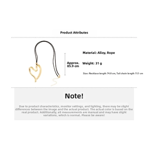 Detail view of irregular gold heart pendant on black rope chain with dimensions