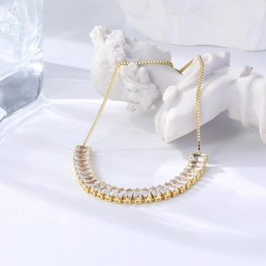 Close-up of golden marquise zircon adjustable bracelet draped on a white plaster statue