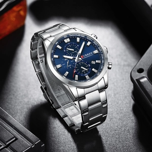 Detailed close-up of CURREN chronograph watch with blue dial and silver steel band