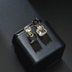 Asymmetric gold square crystal stud earrings with number 5 and clover charm details