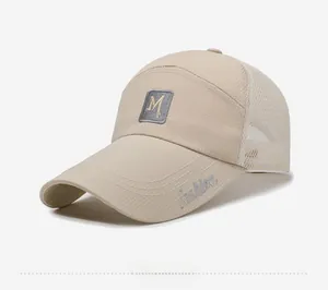 Detail of beige breathable mesh baseball cap featuring side Fashion text and M logo