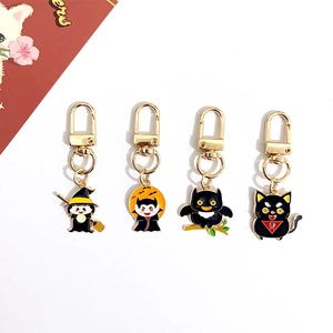 Set of 4 Halloween enamel keychains with witch, vampire, owl, and black cat designs